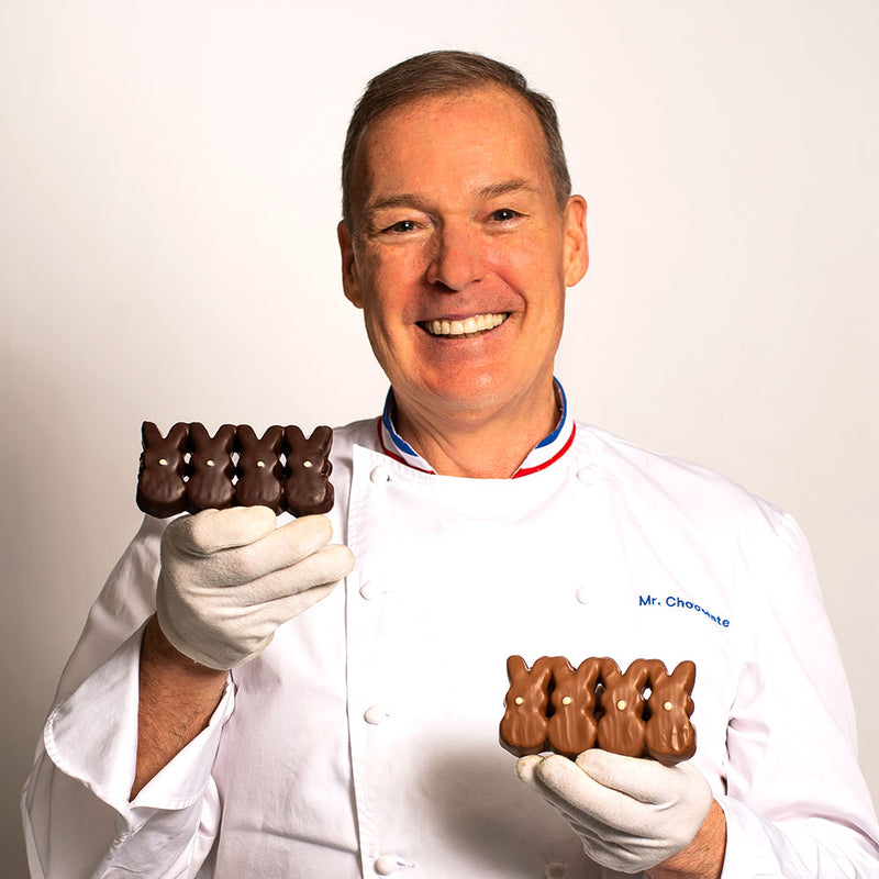 Chef Jacques Torres holding milk and dark chocolate covered Easter bunny peeps