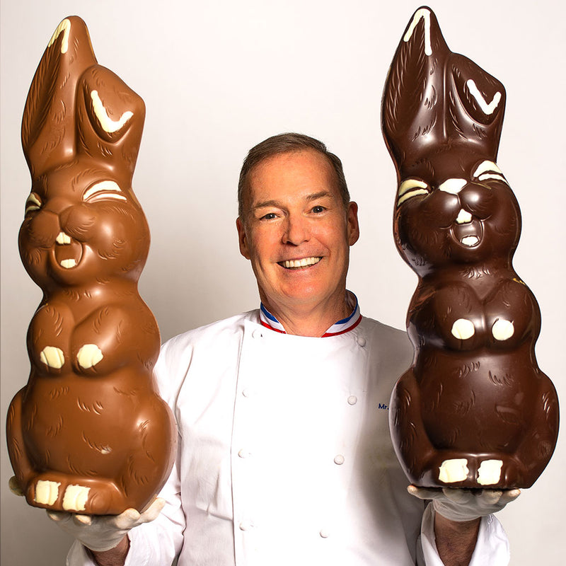 Chef Jacques Torres holding giant smiling Easter bunny in milk and dark chocolate