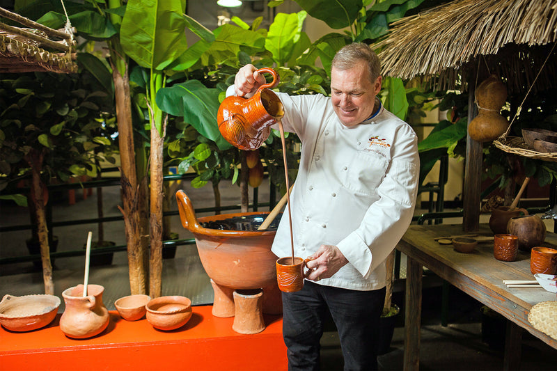 Chef Jacques Torres pours melted hot chocolate at the Choco-Story Museum
