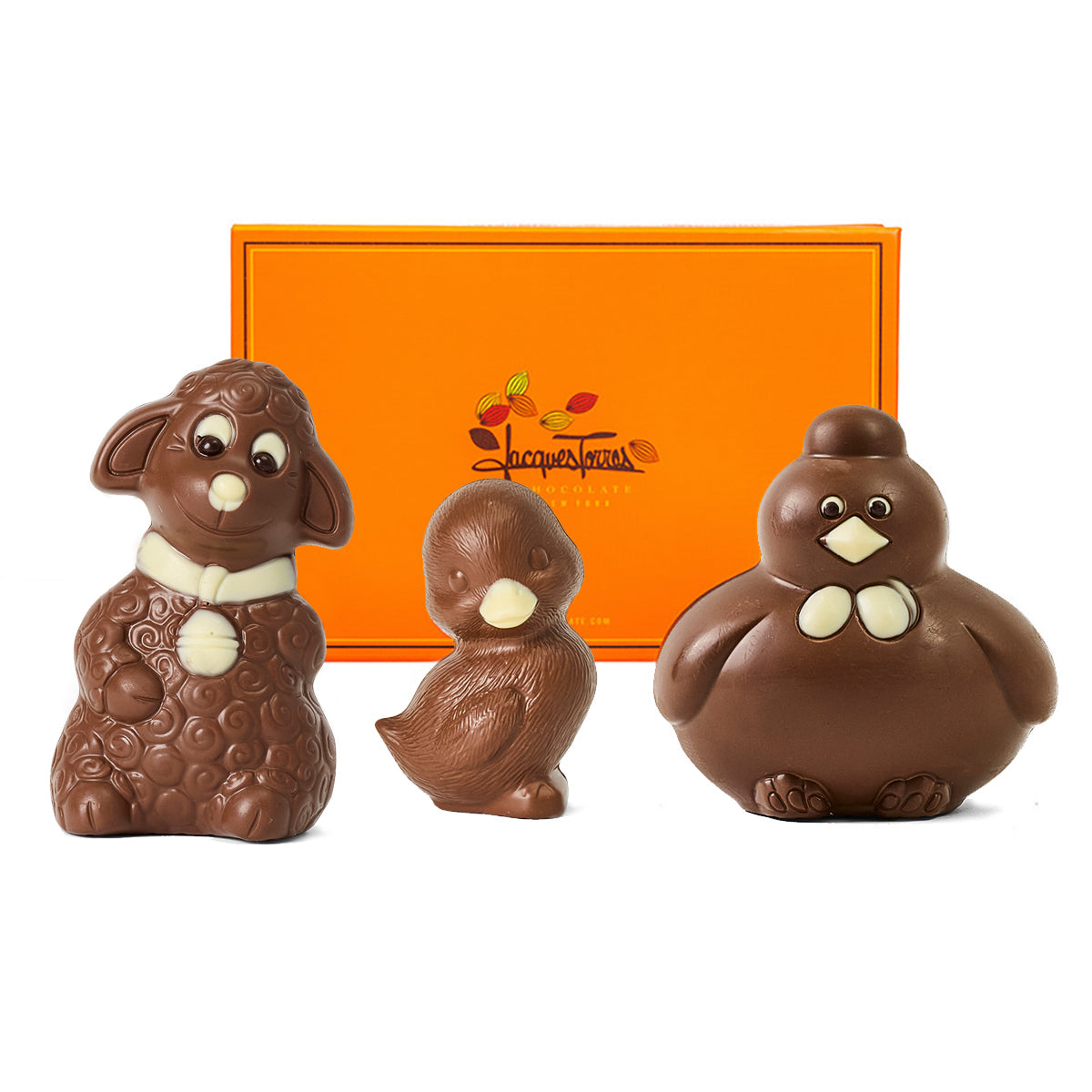 Three chocolate animal figurines in front of an orange box with a brand logo.