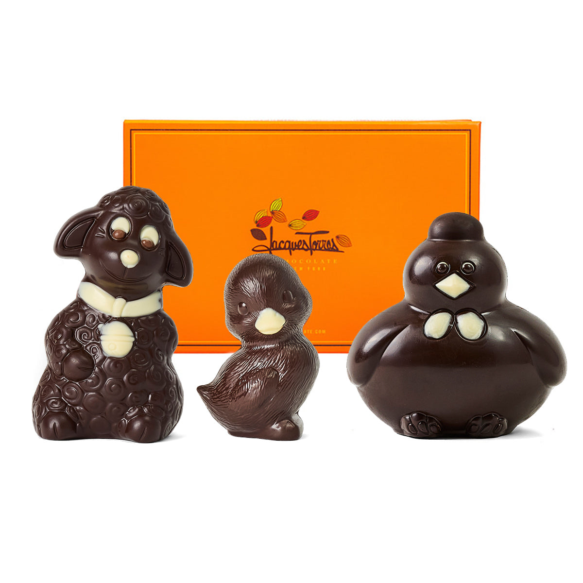 Three chocolate animal figurines in front of a Jacques Torres box.