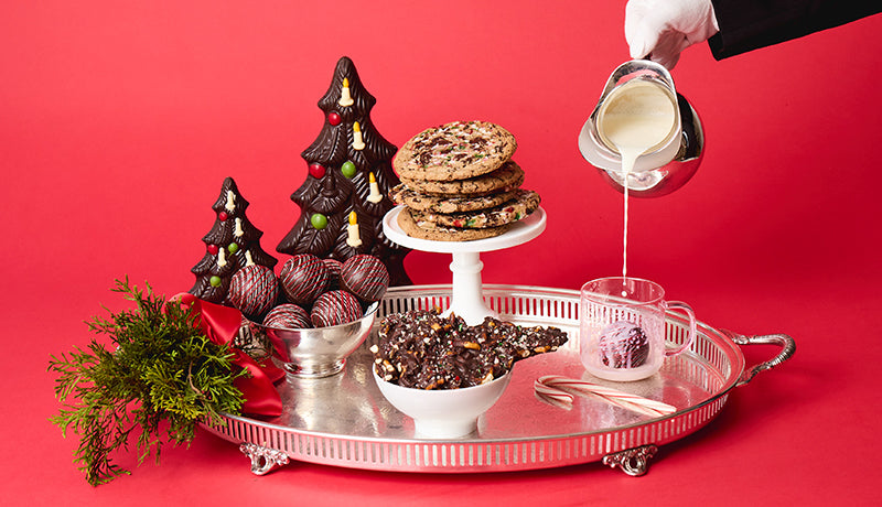 Cookies, bark and hot chocolate bombs on a silver tray