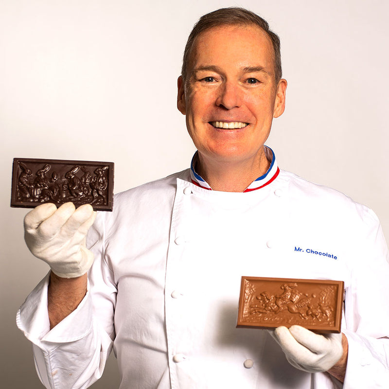Chef Jacques Torres holding milk and dark chocolate Easter bars