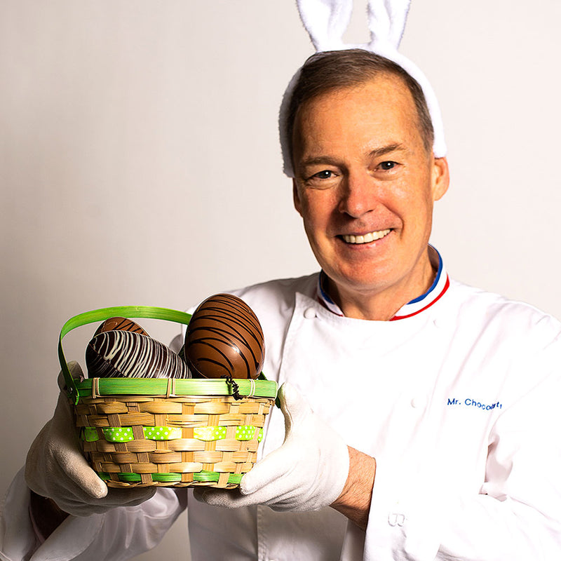 Chef Jacques Torres holding Classic milk and dark chocolate eggs 4.5 inches in basket 