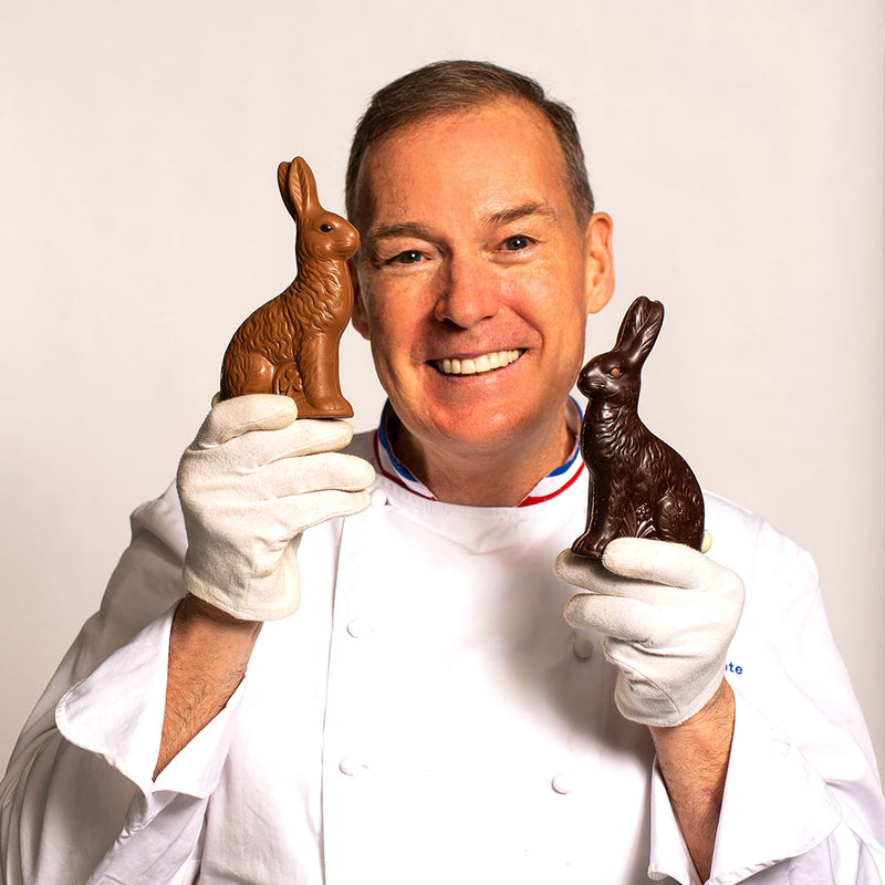 Chef Jacques Torres holding sitting Easter bunny in milk and dark chocolate