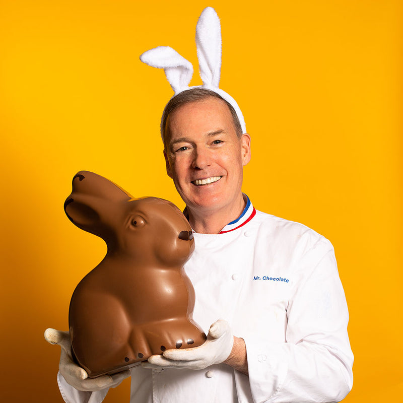Chef Jacques Torres holding giant sitting chocolate Easter bunny