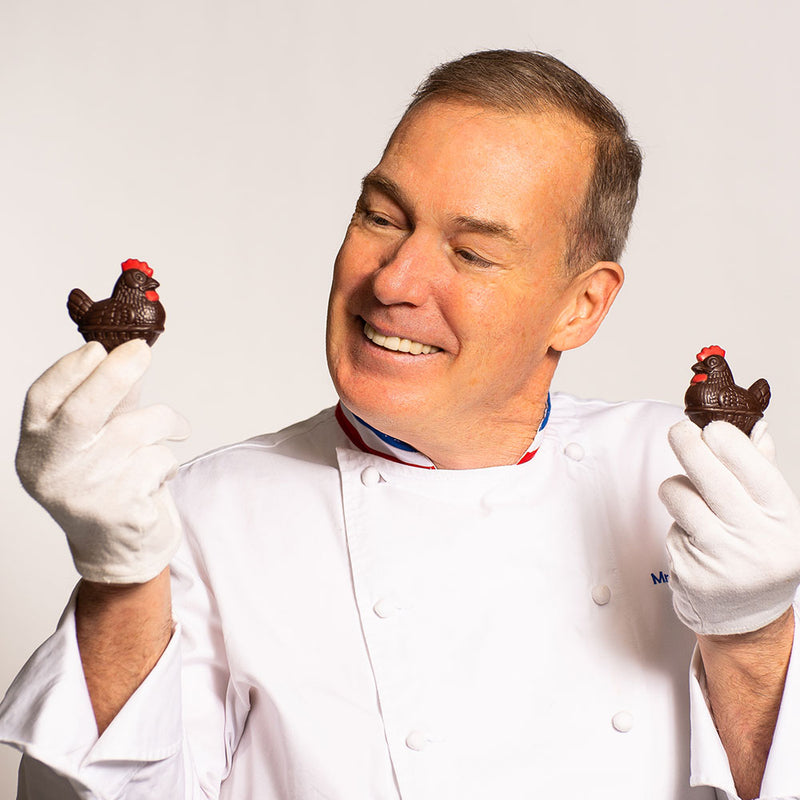 Chef Jacques Torres holding small 2.5 inch Easter hen in milk and dark chocolate