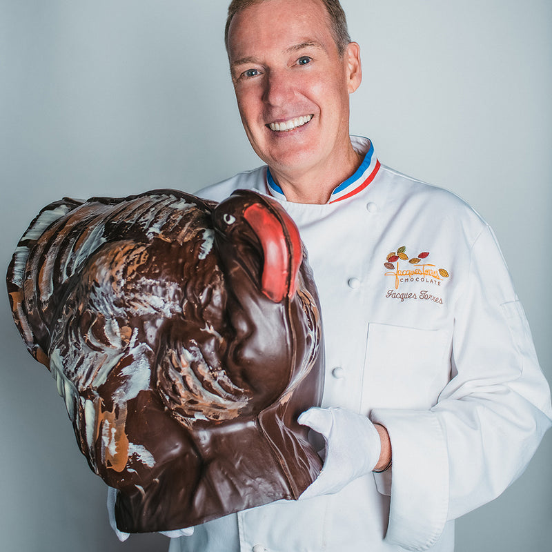 Jacques Torres holding large dark chocolate turkey