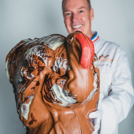 Jacques Torres holding large milk chocolate turkey