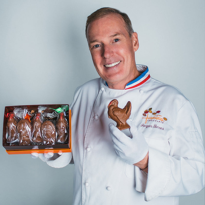 Jacques Torres holding small chocolate turkeys